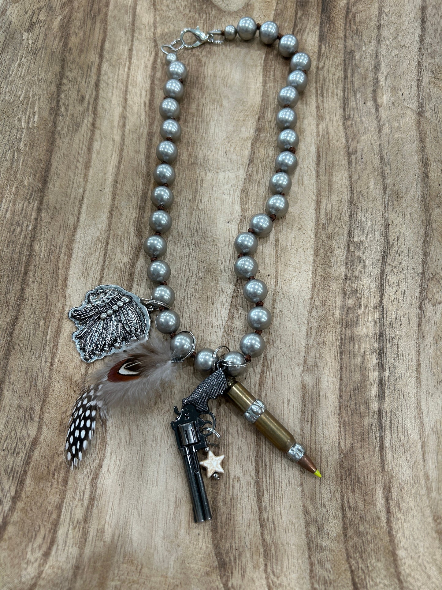 Metal Pistol and Native American-Themed Necklace