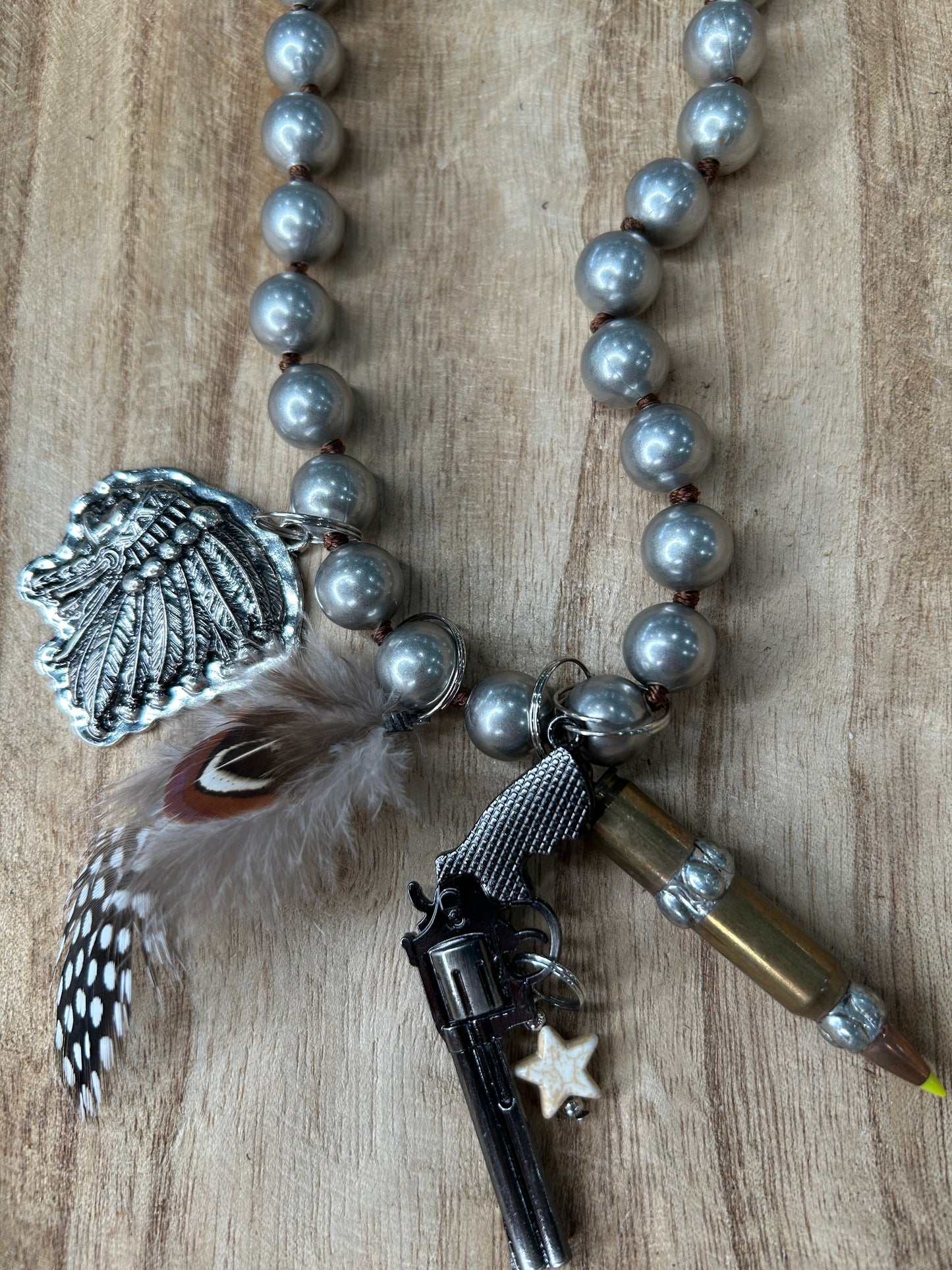 Metal Pistol and Native American-Themed Necklace