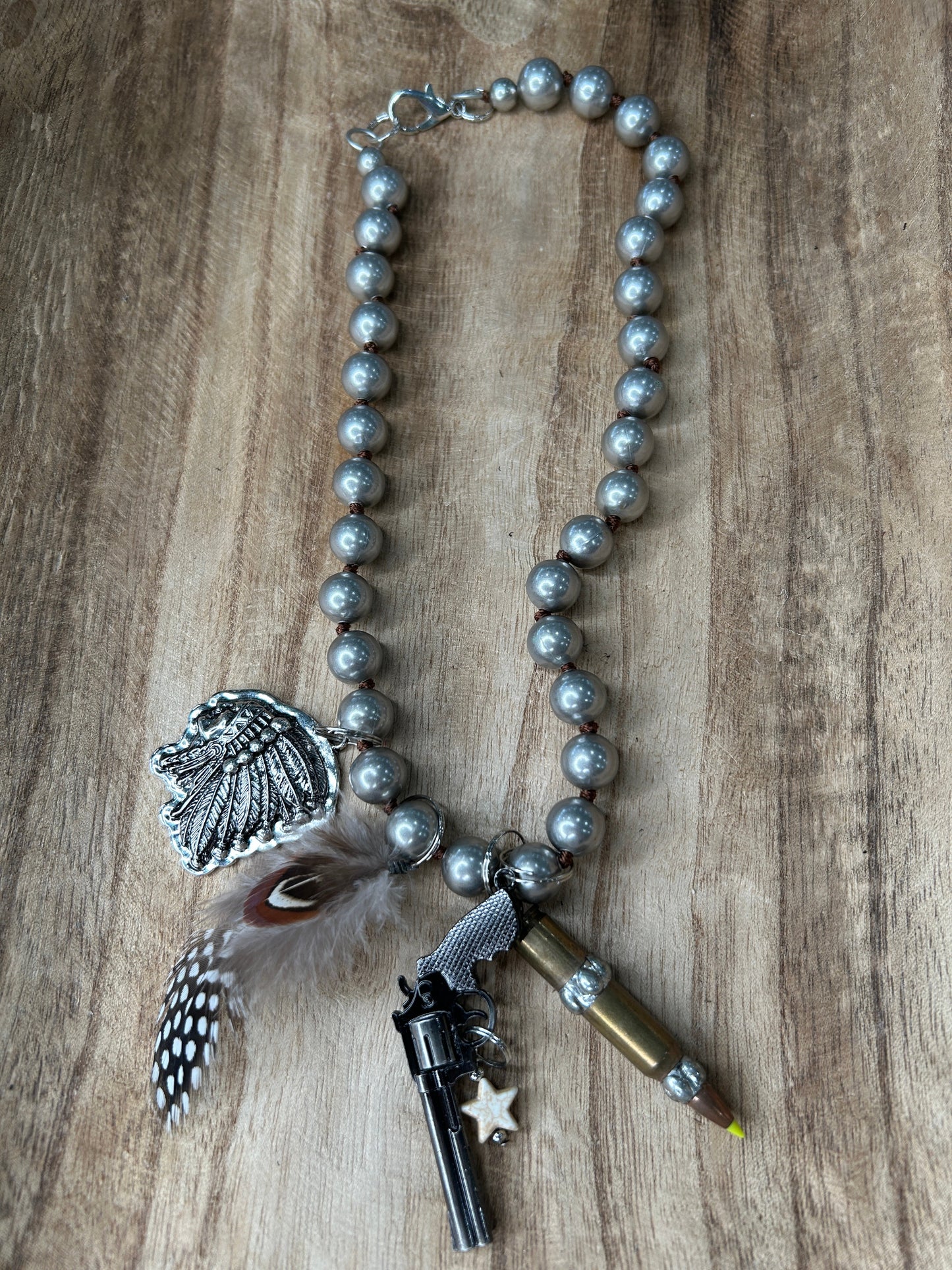 Metal Pistol and Native American-Themed Necklace